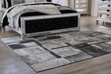 Medium Ashley Furniture Brycebourne 5'3" x 7'7" rug with intricate patterns, soft texture, and neutral colors for stylish home decor.