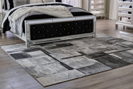 Medium Ashley Furniture Brycebourne 5'3" x 7'7" rug with intricate patterns, soft texture, and neutral colors for stylish home decor.