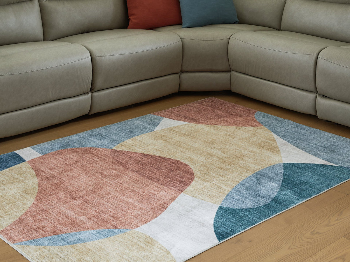 Medium Ashley Furniture Chanleigh washable 5x7 area rug with intricate pattern, shown in a cropped view.