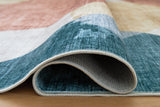 Medium Ashley Furniture Chanleigh washable 5' x 7' area rug with intricate pattern and soft texture, shown in detail.
