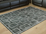 Medium Ashley Furniture Elderland washable area rug, 5' x 7', with a detailed pattern and soft texture, suitable for living rooms or bedrooms.