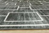 Medium Ashley Furniture Elderland washable 5' x 7' area rug with intricate pattern and soft texture, suitable for living spaces.