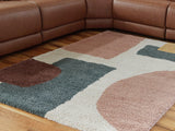 Medium Flynnwick 5x7 rug by Ashley Furniture with a detailed patterned design in neutral tones.