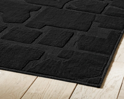 Medium Ashley Furniture Gibbswell washable 5x7 area rug with intricate pattern and soft texture, ideal for living room or bedroom decor.