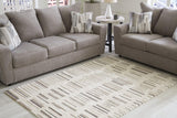 Medium Ashley Furniture Leesdale 5x7 rug with intricate patterns and neutral colors, perfect for living room or bedroom decor.