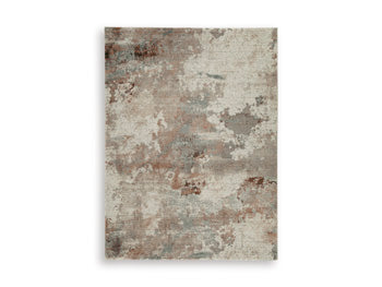 Ashley Furniture Jadenburg Rug with intricate patterns in neutral tones, showcasing a plush, woven texture.