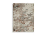 Ashley Furniture Jadenburg Rug with intricate patterns in neutral tones, showcasing a plush, woven texture.