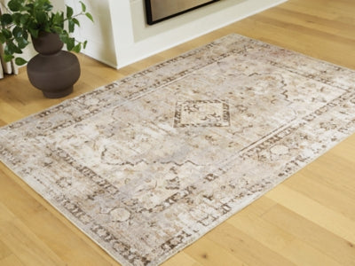 Ashley Furniture Livdon washable rug with geometric pattern in neutral tones, shown in a close-up view.