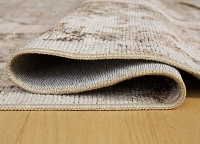 Ashley Furniture Livdon washable rug with intricate pattern, showcasing its soft texture and durable design in a close-up view.