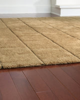 Close-up of the Luzmont Rug by Ashley Furniture, showcasing its detailed woven pattern and soft, textured surface.