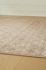 Close-up of the Ashley Furniture Lyamford Rug showcasing intricate woven patterns and textured fabric in neutral tones.