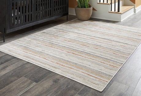 Medium Ashley Furniture Artney Rug with intricate patterns, showcasing soft textures and warm tones for cozy living spaces.