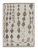 Medium Ashley Furniture Brettler Rug with intricate pattern and soft texture, ideal for living room or bedroom decor.
