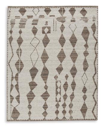 Medium Ashley Furniture Brettler Rug with intricate woven pattern in neutral tones on a light-colored floor.