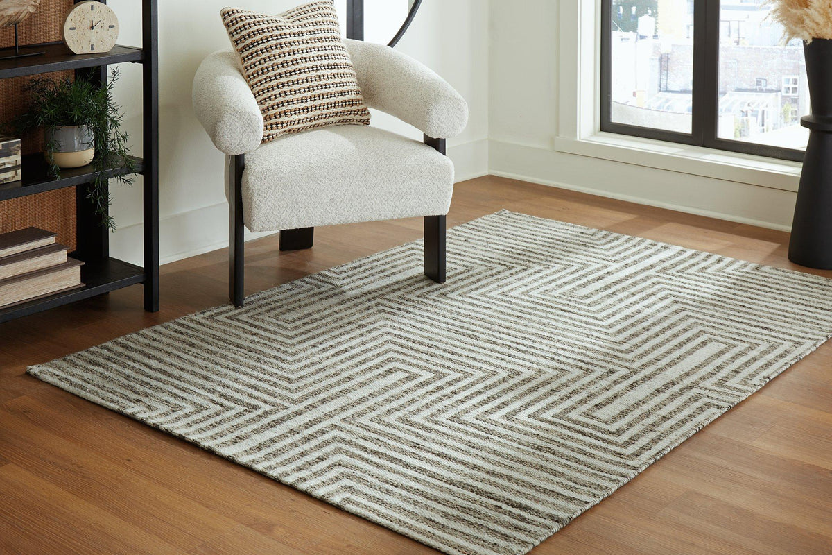 Medium Ashley Furniture Jossen Rug with intricate woven pattern, showcasing soft neutral tones and textured surface.