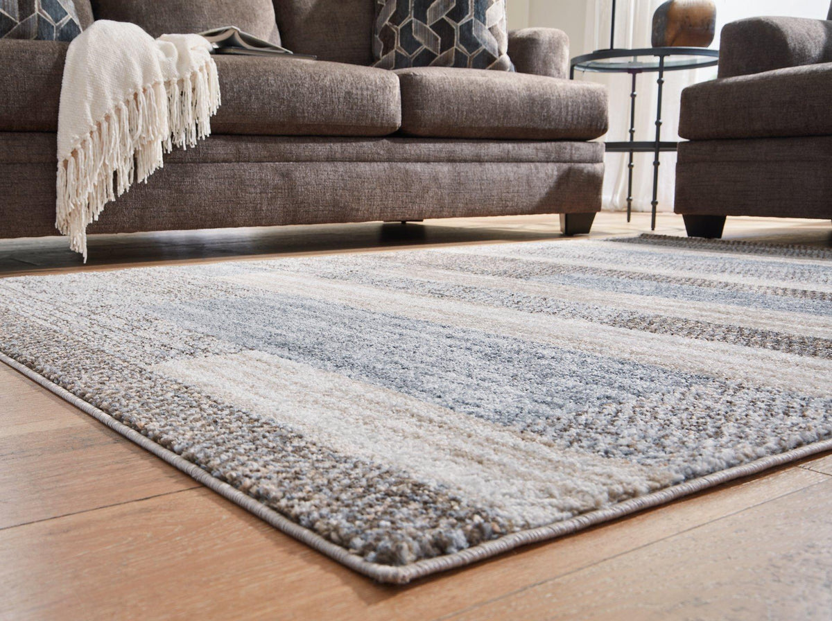 Medium Sethburn rug by Ashley Furniture featuring a soft, textured design ideal for living rooms or bedrooms.