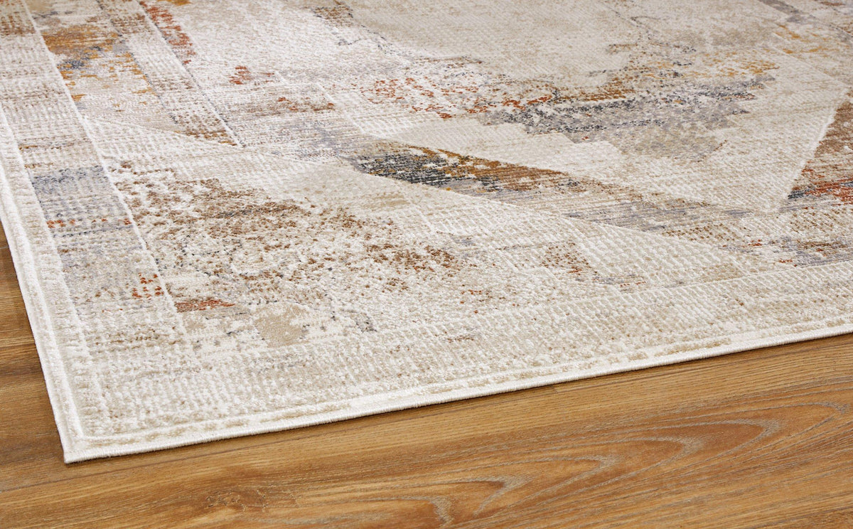 Medium Varnwood Rug by Ashley Furniture featuring a textured, woven design in neutral tones on a light-colored wooden floor.