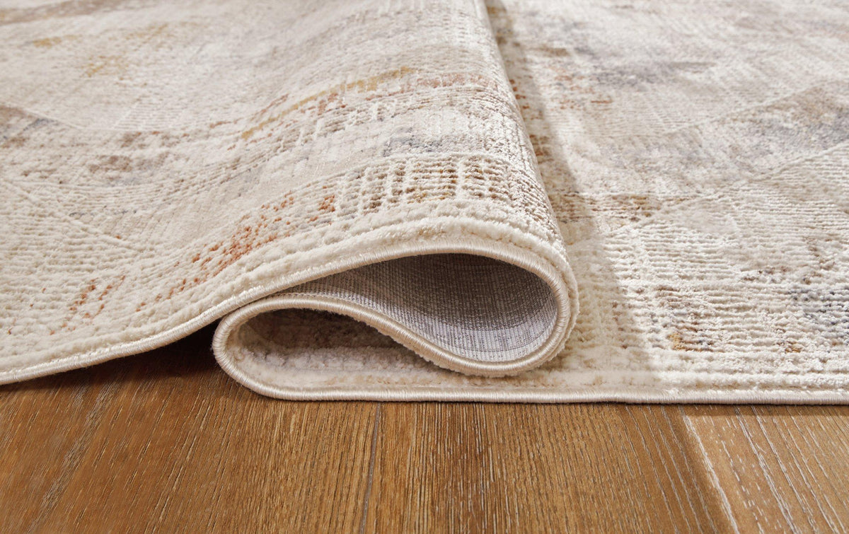 Medium Varnwood Rug by Ashley Furniture with intricate woven pattern in neutral tones, perfect for living room or bedroom decor.