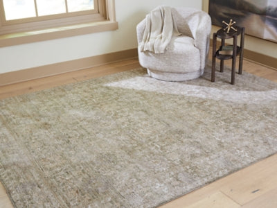 Close-up of Ashley Furniture Neroham Rug with intricate woven pattern in neutral tones, showcasing its textured surface and craftsmanship.