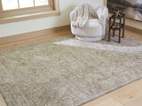 Close-up of Ashley Furniture Neroham Rug with intricate woven pattern in neutral tones, showcasing its textured surface and craftsmanship.