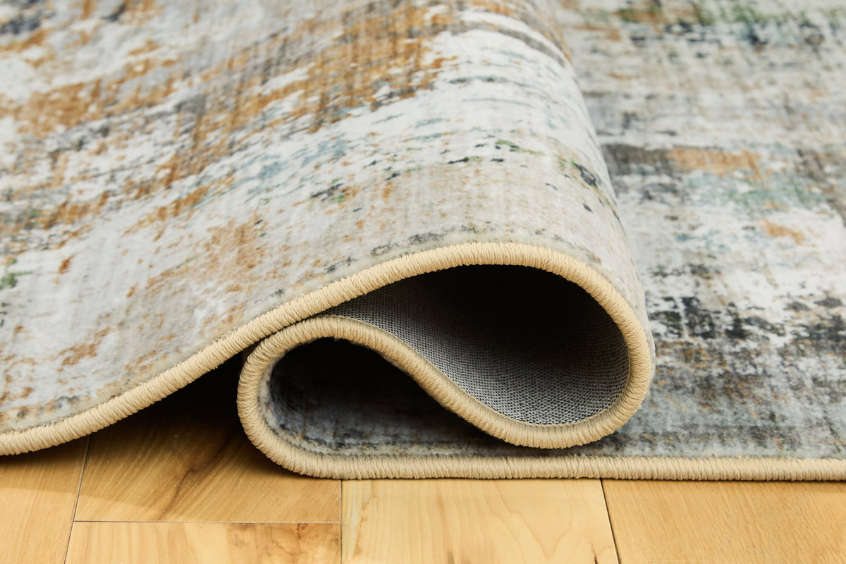 Close-up of Ashley Furniture Torinette Rug showing detailed woven pattern in neutral tones.