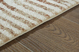 Close-up of the Uduak Rug by Ashley Furniture, showcasing its detailed woven pattern and rich earthy tones.
