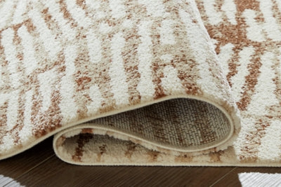 Close-up of the Ashley Furniture Uduak Rug showing its detailed woven pattern in neutral tones.