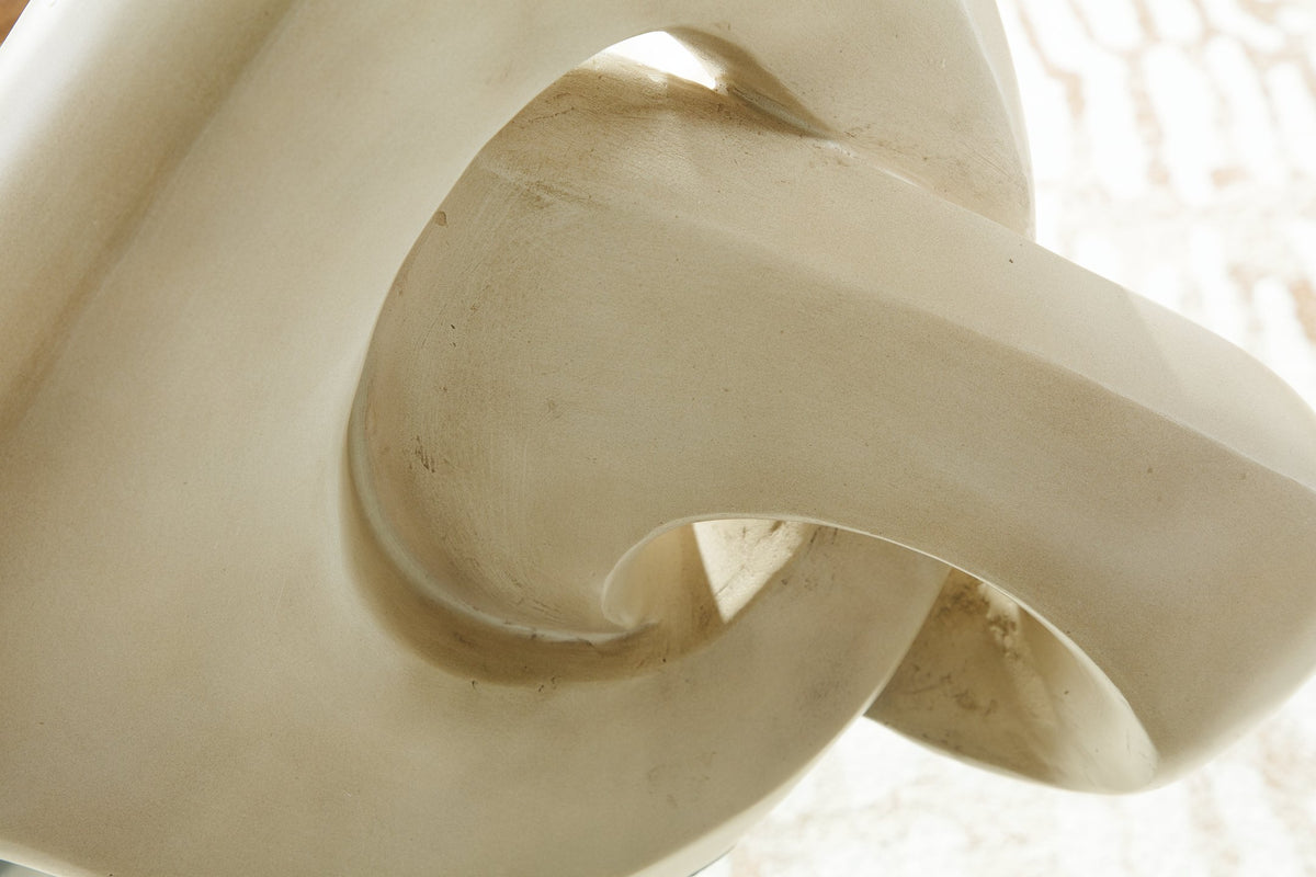 Close-up of the Ashley Furniture Feebs sculpture showcasing detailed craftsmanship and smooth, artistic design.