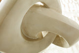 Close-up of the Ashley Furniture Feebs sculpture showcasing detailed craftsmanship and smooth, artistic design.