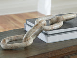 Ashley Furniture Kenport Sculpture, modern decorative sculpture with geometric design, displayed on a neutral surface.