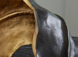 Melinda sculpture by Ashley Furniture featuring a modern abstract design, displayed on a wooden surface.