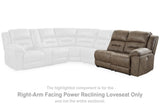 Ashley Furniture Ravenel Power Reclining Sectional shown in a modern living room with plush cushions and dark fabric upholstery.