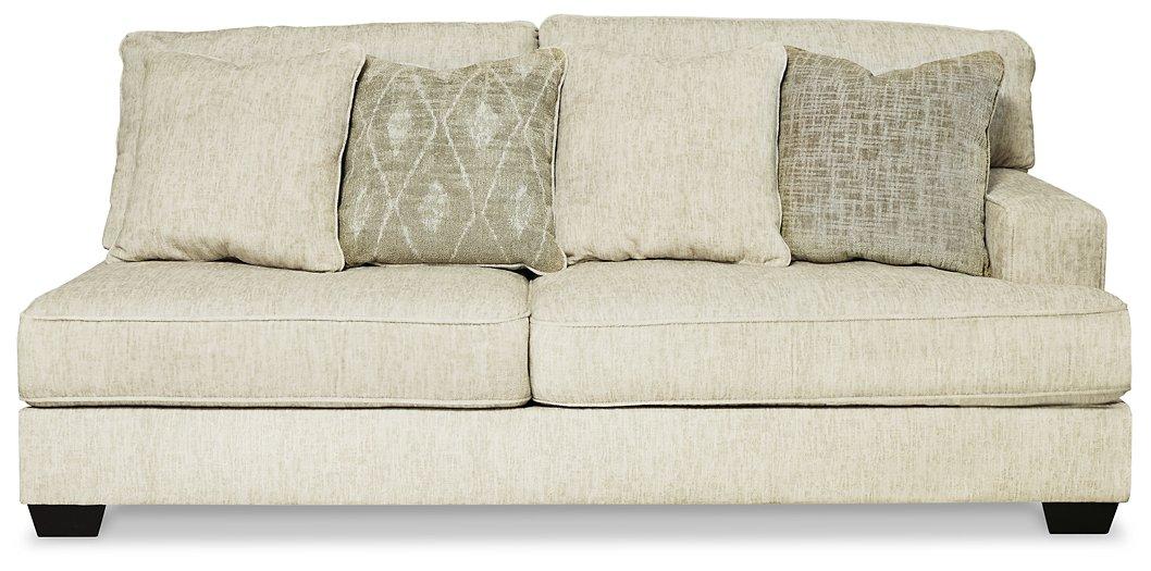 Ashley Furniture Rawcliffe sectional sofa with plush cushions and neutral fabric, shown in a spacious living room setting.