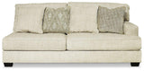 Ashley Furniture Rawcliffe sectional sofa with plush cushions and neutral fabric, shown in a spacious living room setting.
