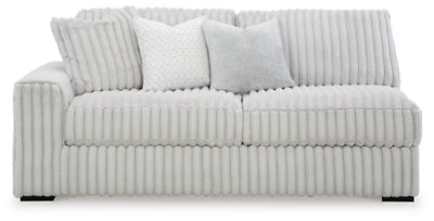 Ashley Furniture Stupendous Sectional sofa with plush cushions and dark fabric, shown from a head-on angle.