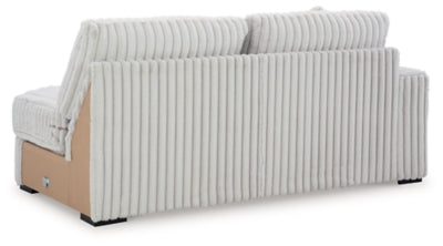 Ashley Furniture Stupendous sectional sofa with plush cushions and fabric upholstery, shown from the back view.