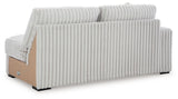 Ashley Furniture Stupendous sectional sofa with plush cushions and fabric upholstery, shown from the back view.