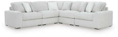 Ashley Furniture Stupendous sectional sofa with plush cushions and modern design, shown in a spacious living room setting.