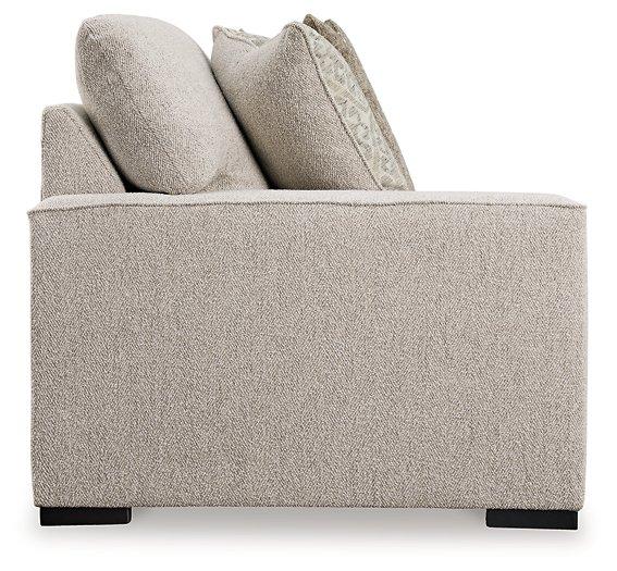 Ashley Furniture Ballyton Sectional sofa with plush cushions and neutral fabric, ideal for modern living room comfort.