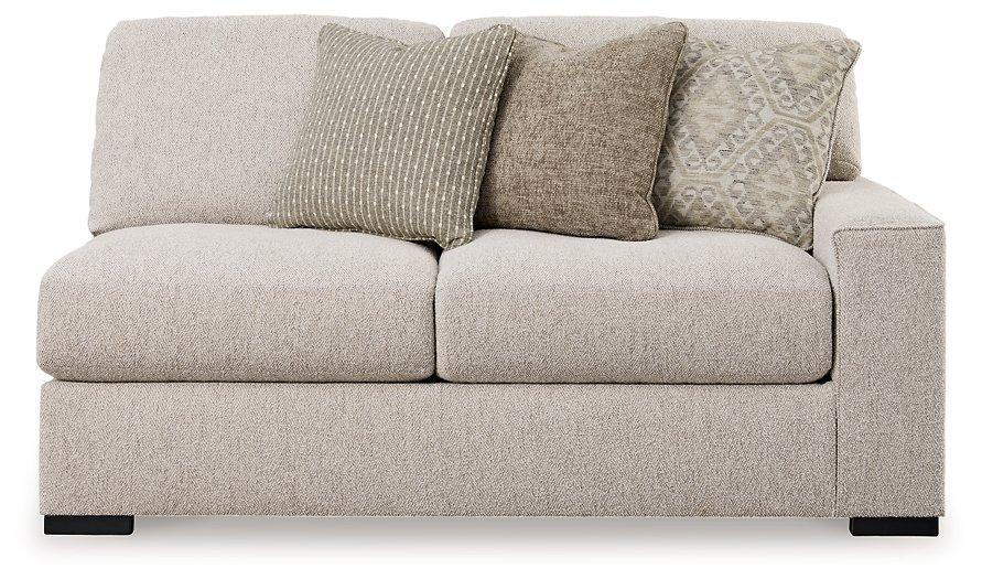 Ashley Furniture Ballyton sectional sofa with plush cushions and fabric upholstery, shown in a modern living room setting.