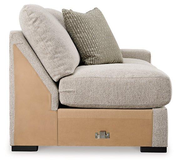 Ashley Furniture Ballyton Sectional sofa with plush cushions and neutral fabric, designed for comfortable living room seating.