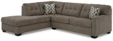 Ashley Furniture Mahoney 2-piece sleeper sectional with chaise, featuring plush fabric and modern design in a living room setting.