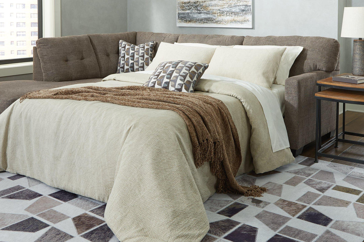 Ashley Furniture Mahoney 2-Piece Sleeper Sectional with Chaise, fabric upholstery, with cushions and chaise lounge for comfortable seating.