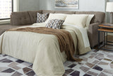 Ashley Furniture Mahoney 2-Piece Sleeper Sectional with Chaise, fabric upholstery, with cushions and chaise lounge for comfortable seating.