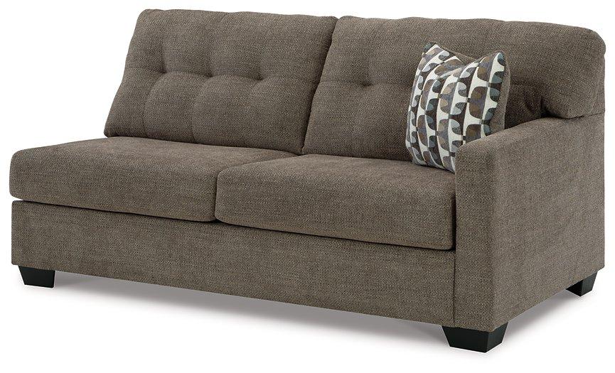 Ashley Mahoney 2-piece sleeper sectional with chaise, beige fabric, modern design, and plush cushions in a stylish living room setting.