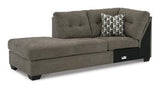 Ashley Mahoney 2-piece sleeper sectional with chaise, featuring plush upholstery and a modern design, perfect for living rooms.