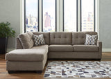 Ashley Mahoney 2-piece sleeper sectional with chaise, beige fabric, plush cushions, and modern design for comfortable living space.