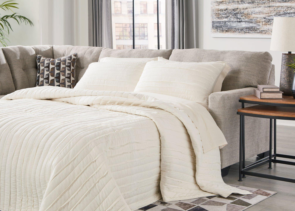 Ashley Furniture Mahoney 2-Piece Sleeper Sectional with Chaise, showing plush fabric and modern design in a living room setting.