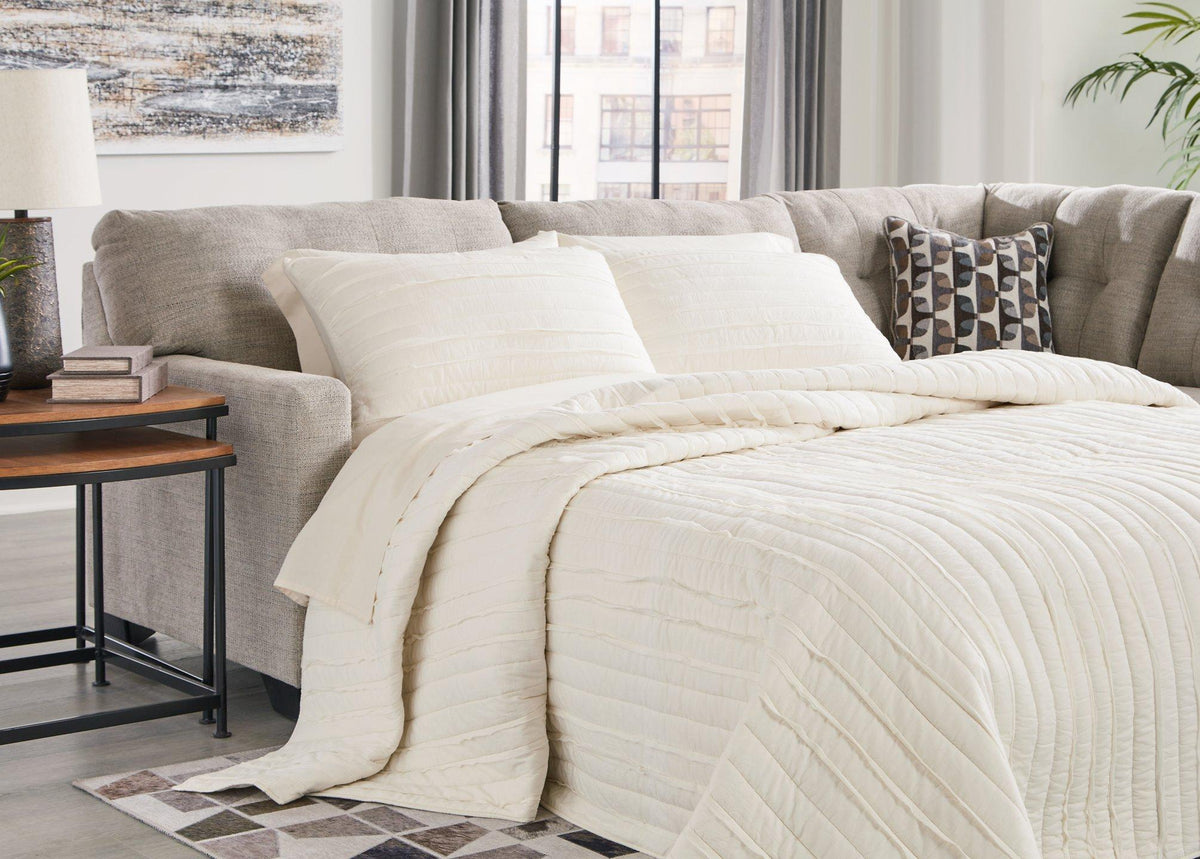 Ashley Furniture Mahoney 2-Piece Sleeper Sectional with Chaise, showing plush fabric, modern design, and comfortable seating arrangement.