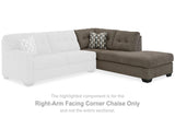 Ashley Mahoney 2-piece sleeper sectional with chaise, featuring plush fabric, modern design, and ample seating in a contemporary living room.